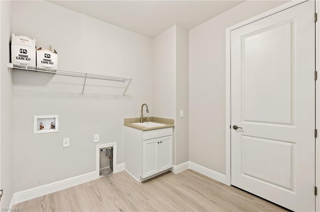 3952 Pegasus Way Naples, FL 34120 - Photo 36 of 50 a room view with wooden floor cabinetry and a sink
