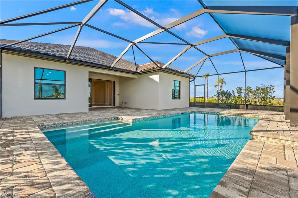 3952 Pegasus Way Naples, FL 34120 - Photo 40 of 50 a swimming pool with barbeque oven