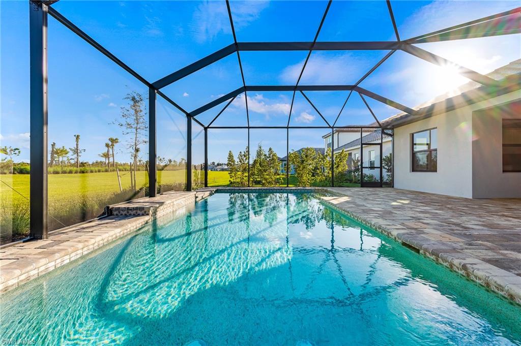 3952 Pegasus Way Naples, FL 34120 - Photo 42 of 50 a view of a swimming pool with a patio