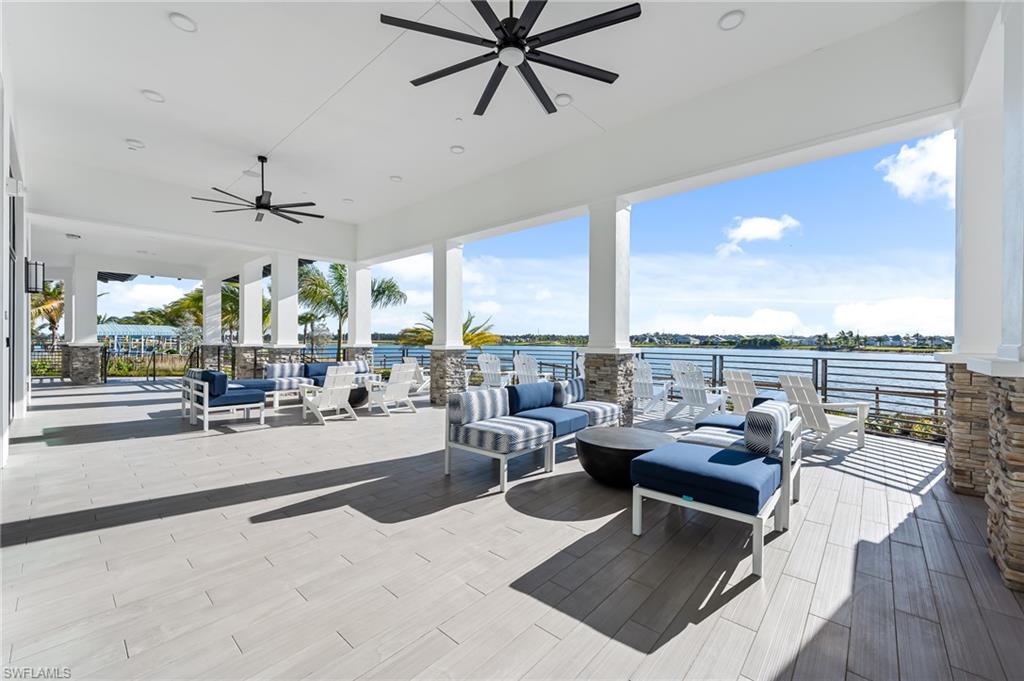 3952 Pegasus Way Naples, FL 34120 - Photo 43 of 50 a living room with patio furniture and a floor to ceiling window