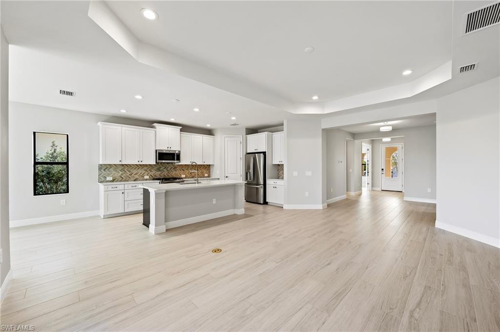 3952 Pegasus Way Naples, FL 34120 - Photo 6 of 50 a view of kitchen with granite countertop white cabinets and refrigerator