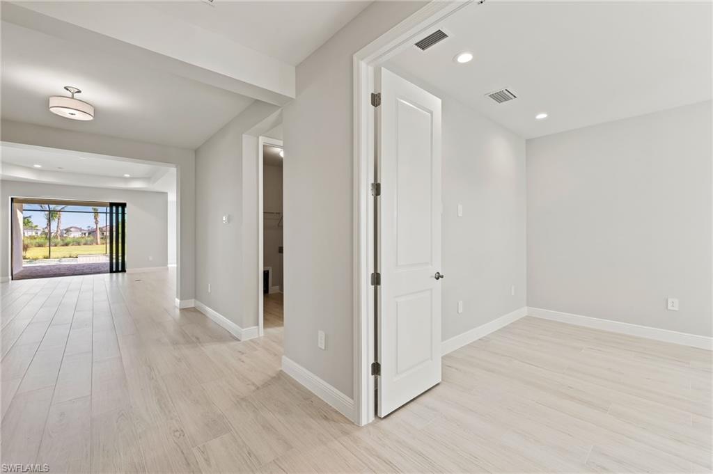 3952 Pegasus Way Naples, FL 34120 - Photo 7 of 50 a view of hallway with wooden floor