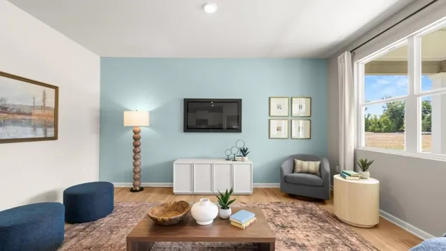 a living room with furniture a flat screen tv and a large window