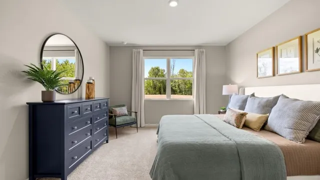 a bedroom with a bed and a potted plant