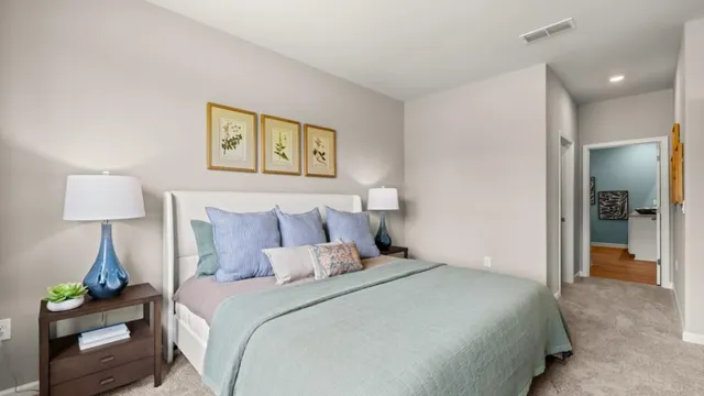 a bedroom with a bed and a lamp