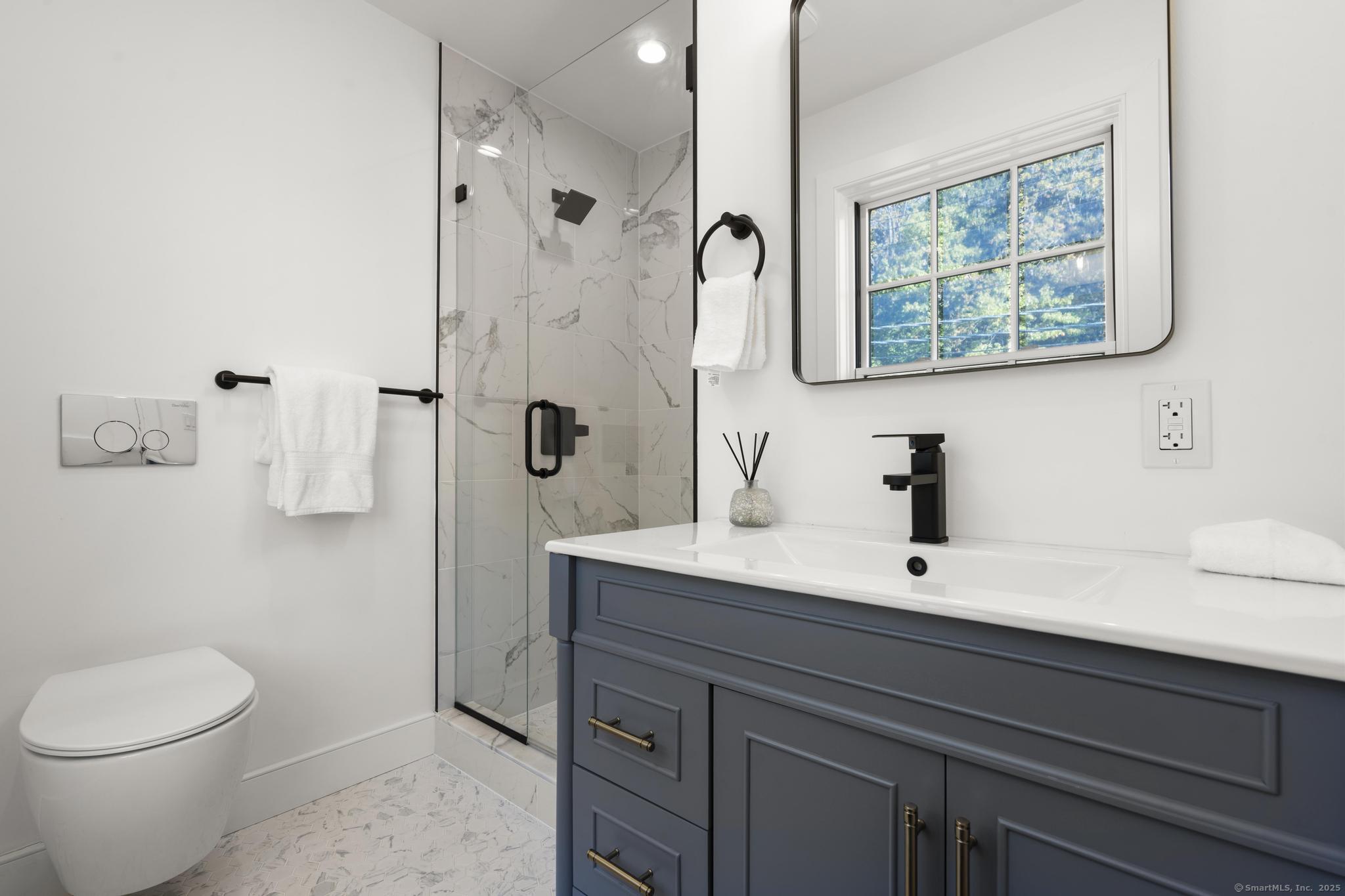 18 Sound Beach Avenue Greenwich, CT 06870 - Photo 18 of 36 a bathroom with a double vanity sink toilet and a mirror