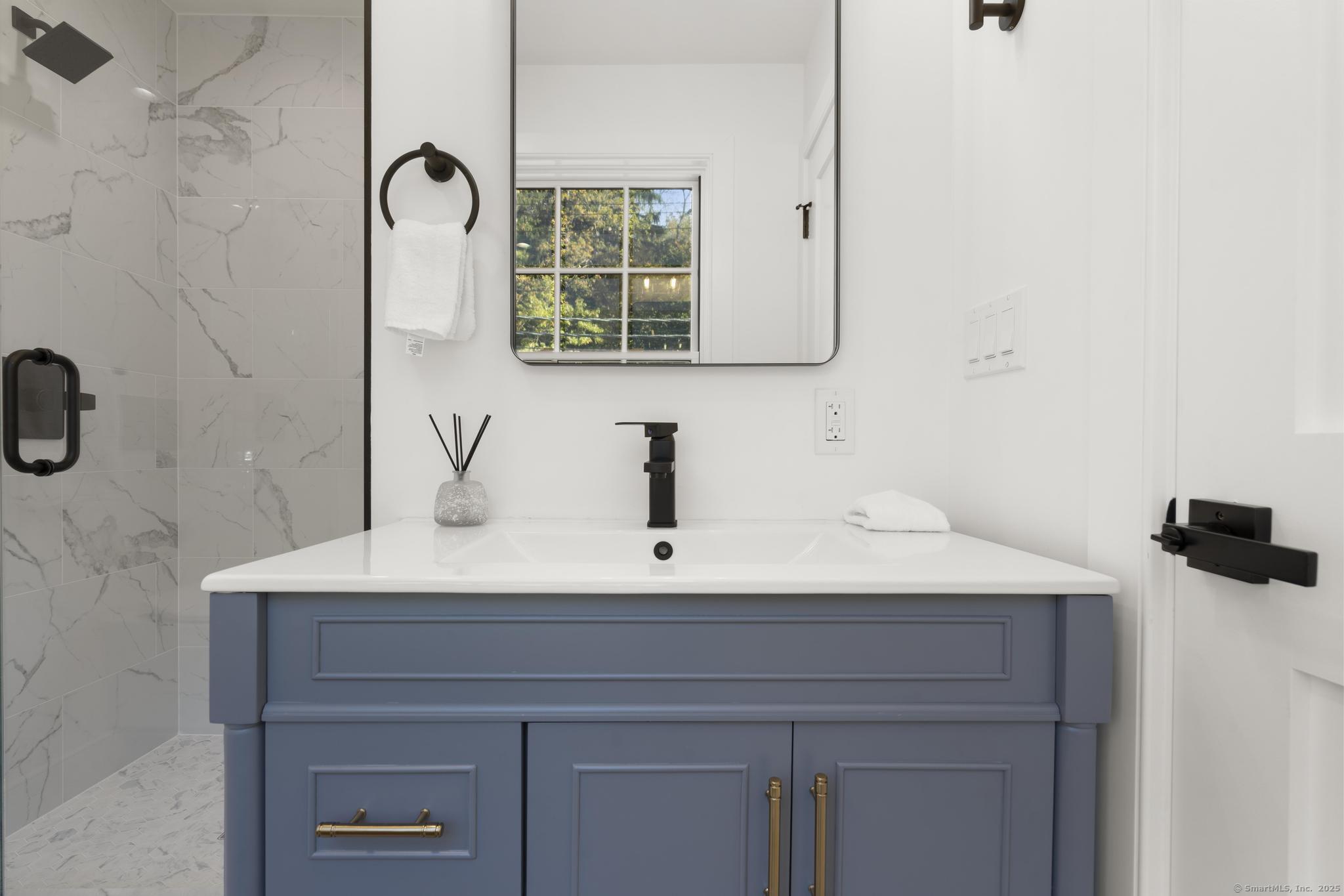 18 Sound Beach Avenue Greenwich, CT 06870 - Photo 19 of 36 a sink with a mirror