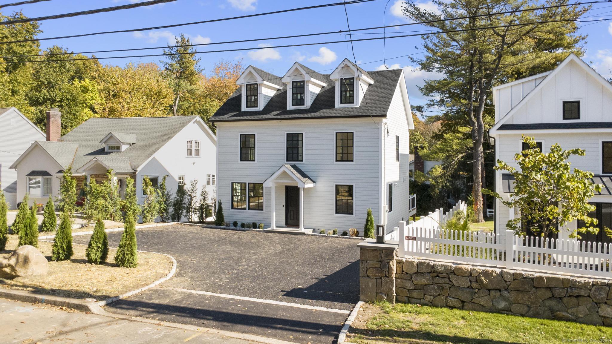 18 Sound Beach Avenue Greenwich, CT 06870 - Photo 2 of 36 a front view of a house with garden