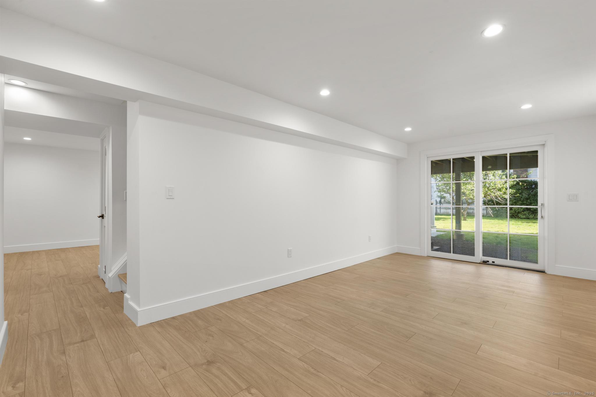18 Sound Beach Avenue Greenwich, CT 06870 - Photo 21 of 36 a view of an empty room with wooden floor and a window