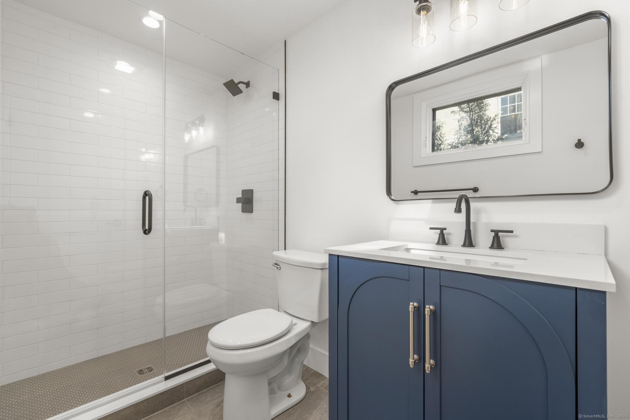 18 Sound Beach Avenue Greenwich, CT 06870 - Photo 24 of 36 a bathroom with a toilet sink and mirror