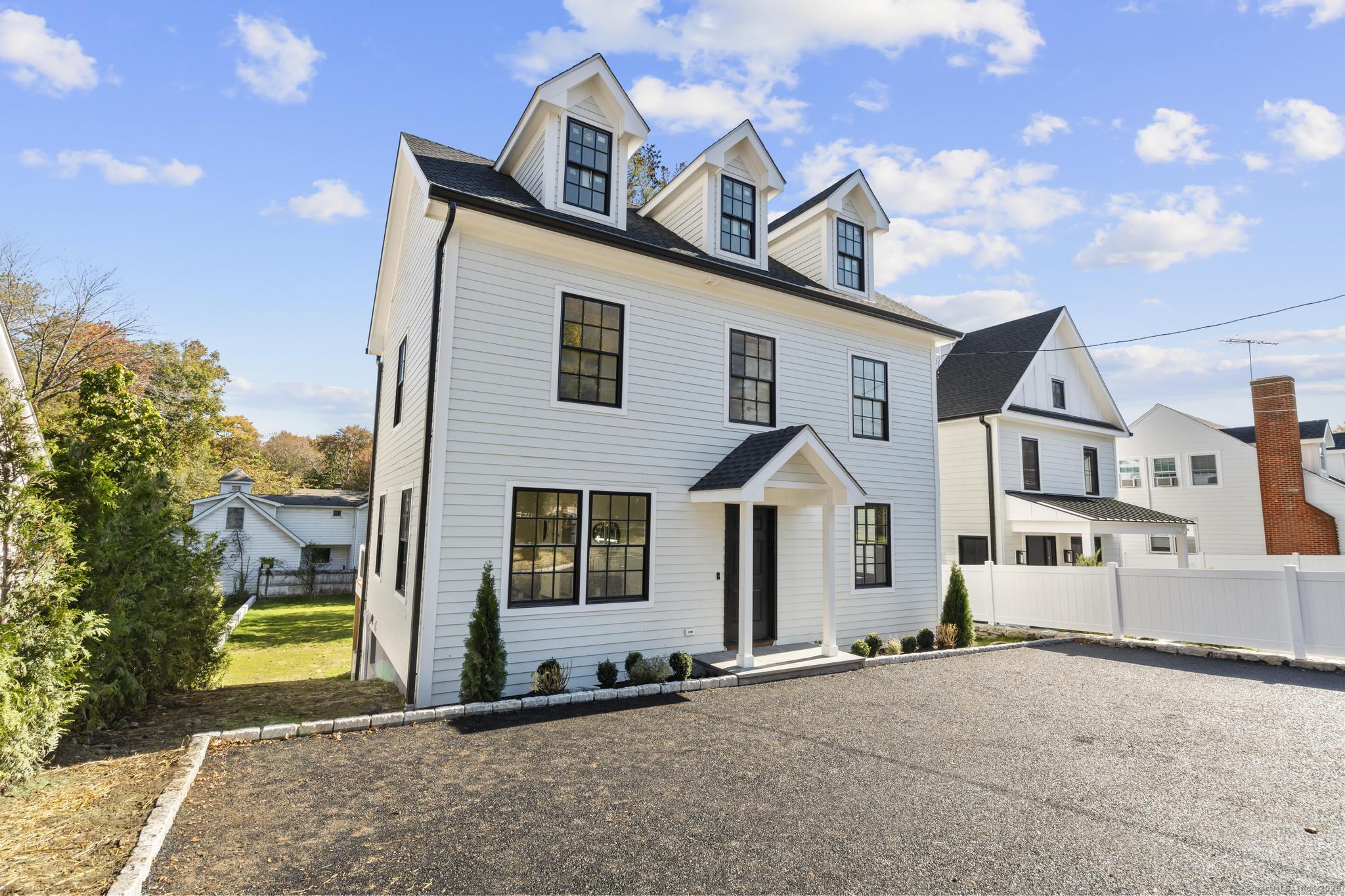18 Sound Beach Avenue Greenwich, CT 06870 - Photo 30 of 36 a front view of a house with a yard