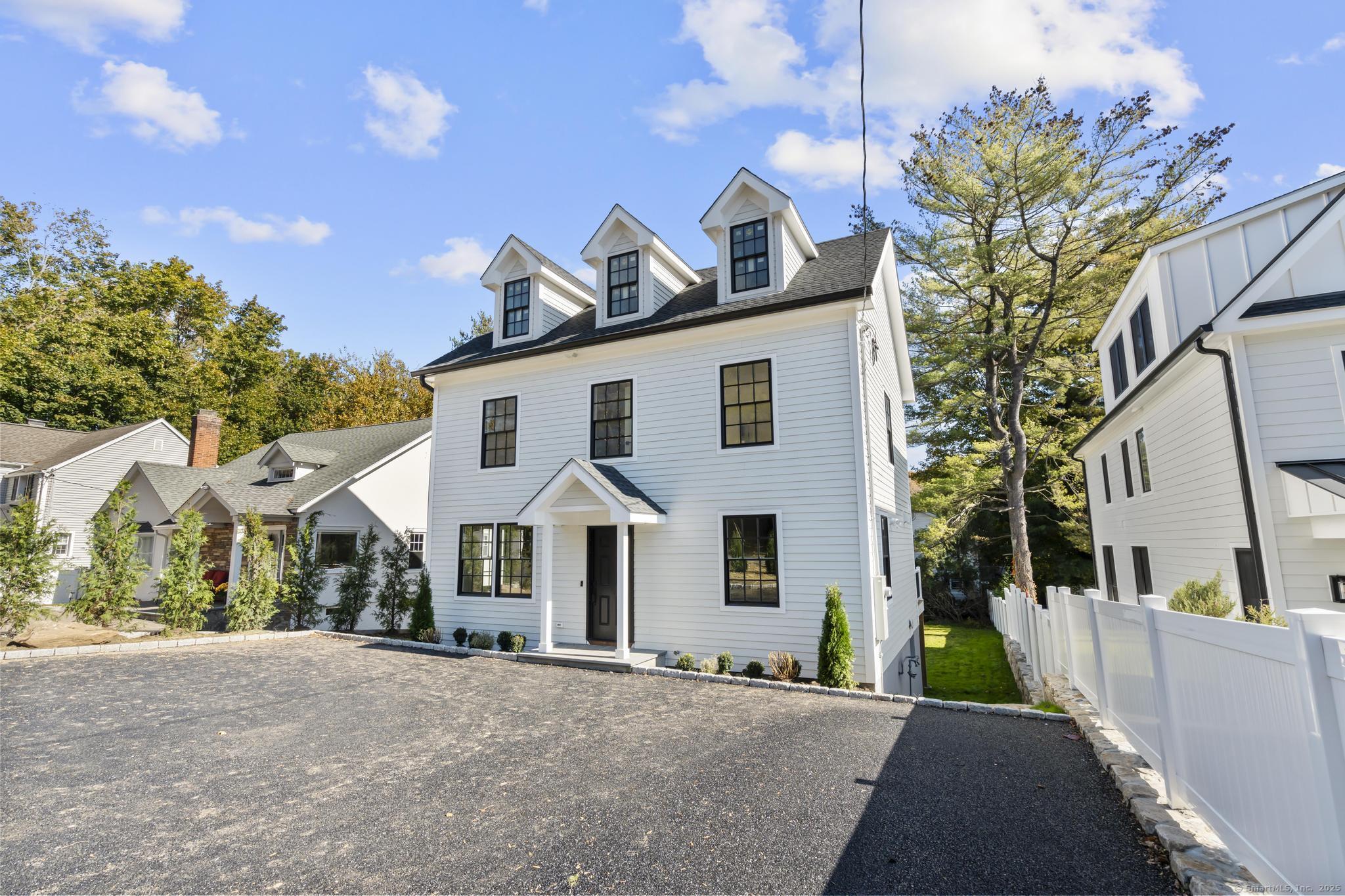 18 Sound Beach Avenue Greenwich, CT 06870 - Photo 31 of 36 a front view of a house with a yard and garage