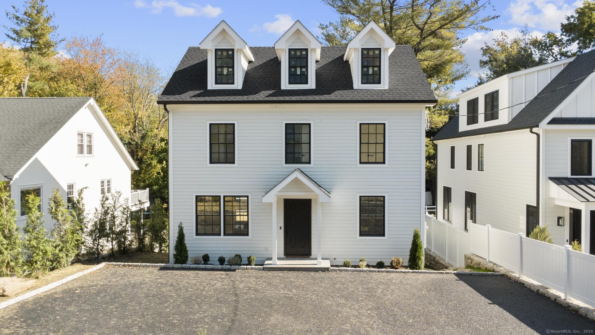18 Sound Beach Avenue Greenwich, CT 06870 - Photo 33 of 36 a front view of a house with a yard