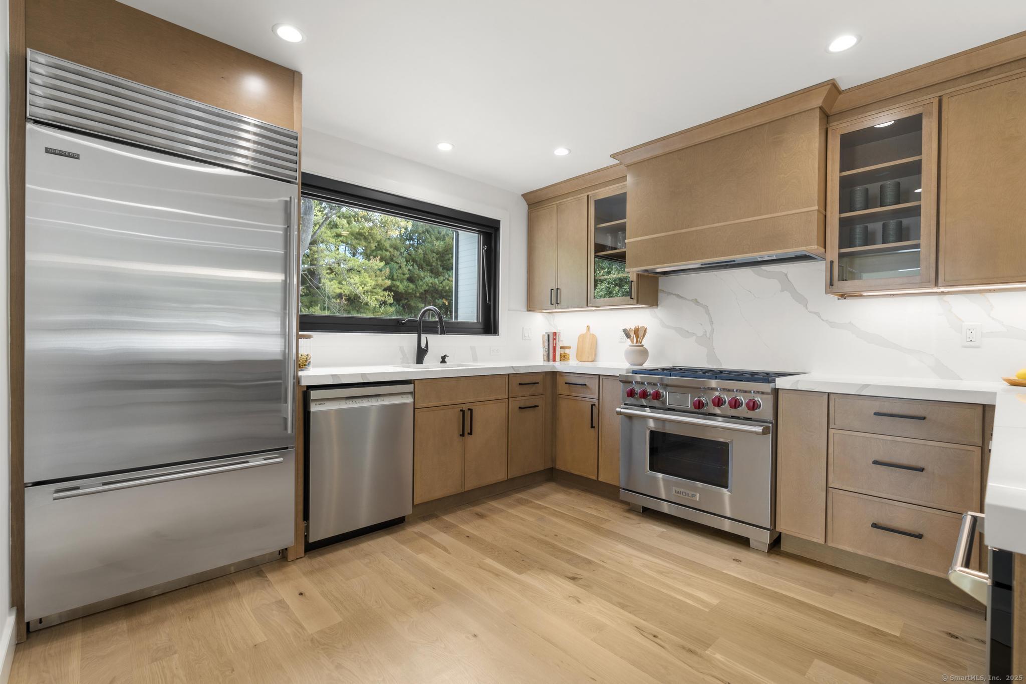 18 Sound Beach Avenue Greenwich, CT 06870 - Photo 4 of 36 a kitchen with stainless steel appliances kitchen island granite countertop a stove and a sink