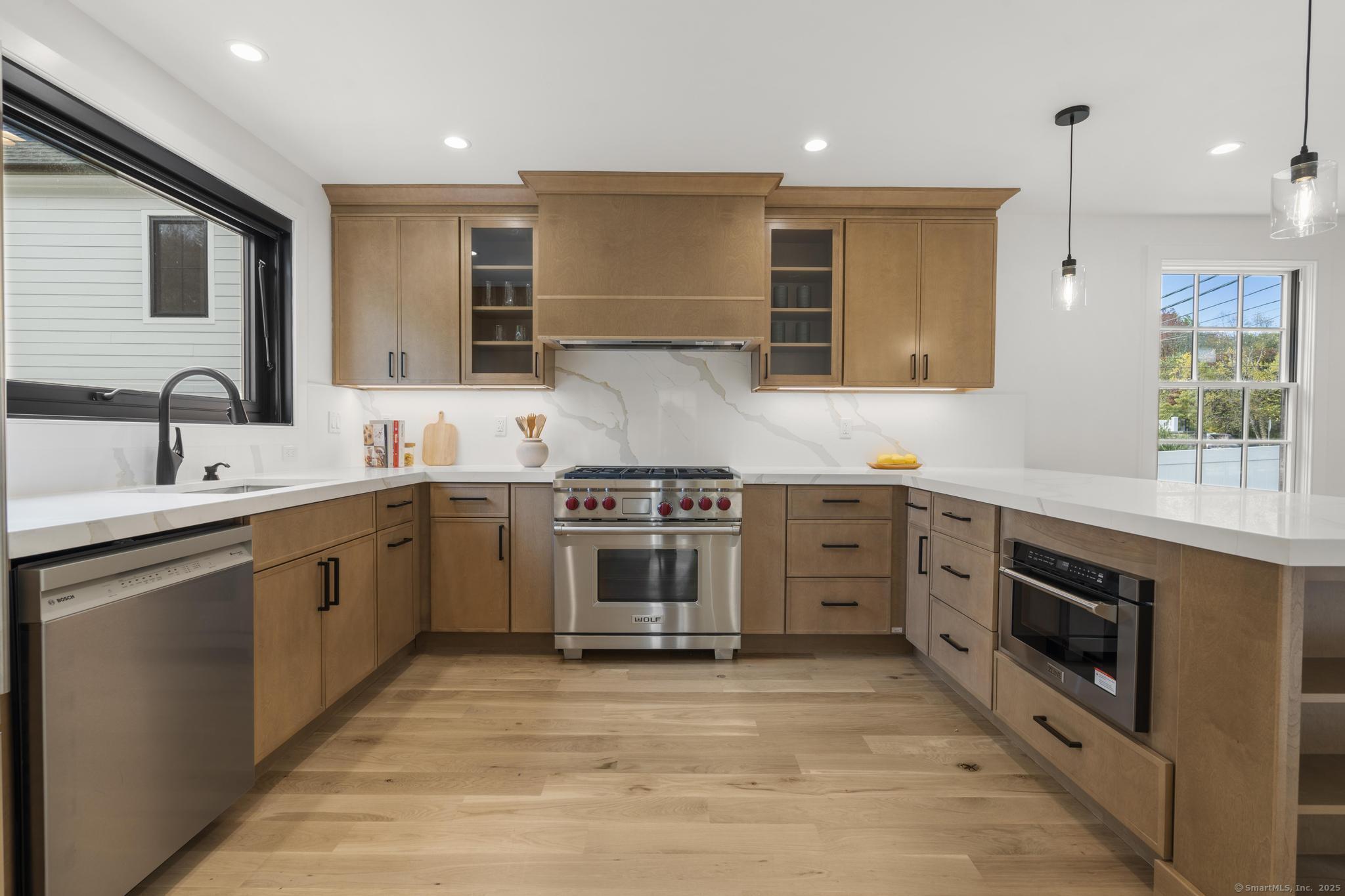 18 Sound Beach Avenue Greenwich, CT 06870 - Photo 5 of 36 a large kitchen with stainless steel appliances granite countertop a stove and a sink