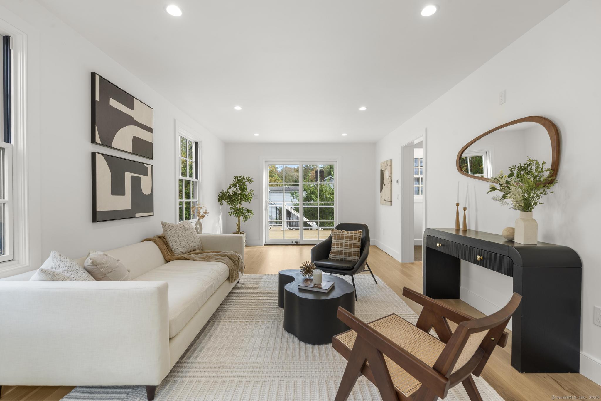 18 Sound Beach Avenue Greenwich, CT 06870 - Photo 8 of 36 a living room with furniture and a large window