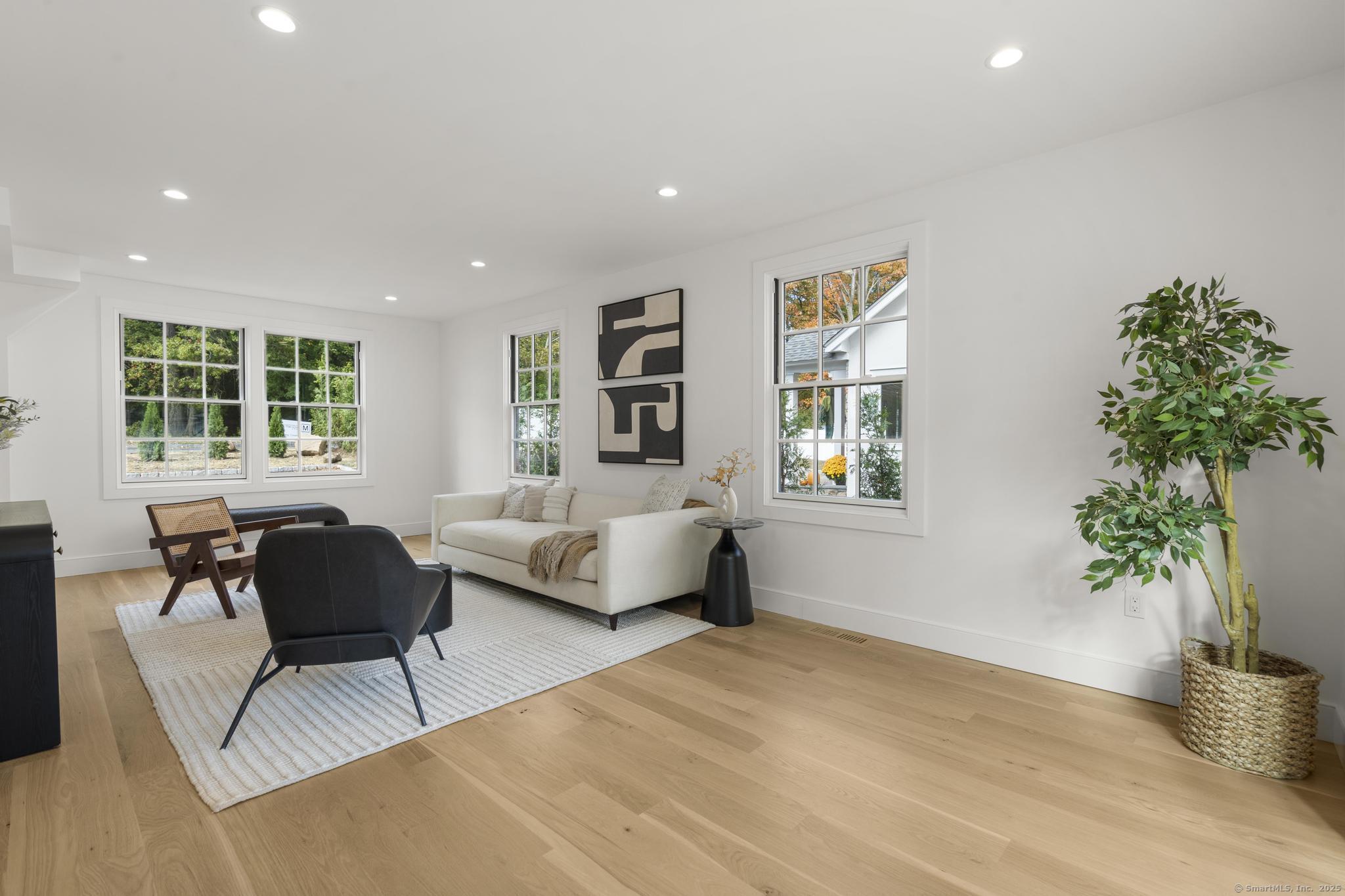 18 Sound Beach Avenue Greenwich, CT 06870 - Photo 9 of 36 a living room with furniture and a potted plant