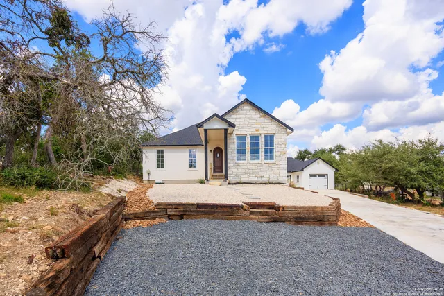 a house that has a tree in front of it