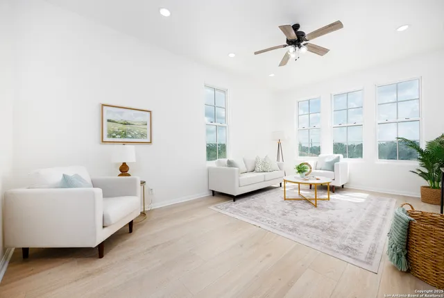 a living room with furniture and a large window