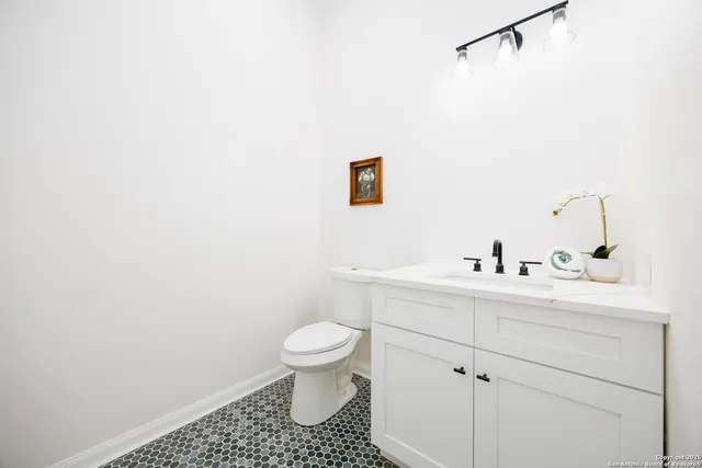 a bathroom with a sink a toilet and vanity