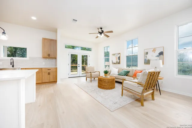a living room with furniture a rug and a chandelier
