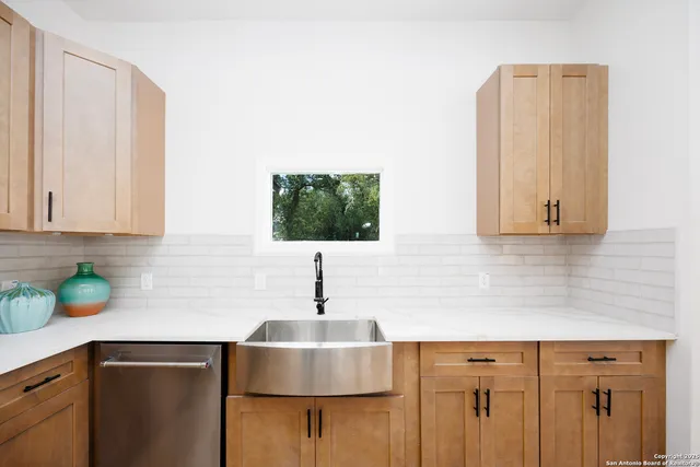 a kitchen with a sink and cabinets