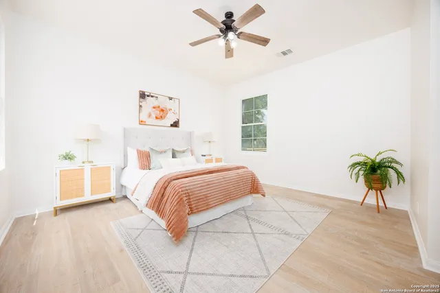 a bedroom with a bed and a potted plant