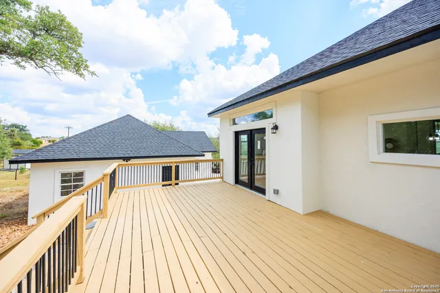 a view of house with pool deck and furniture