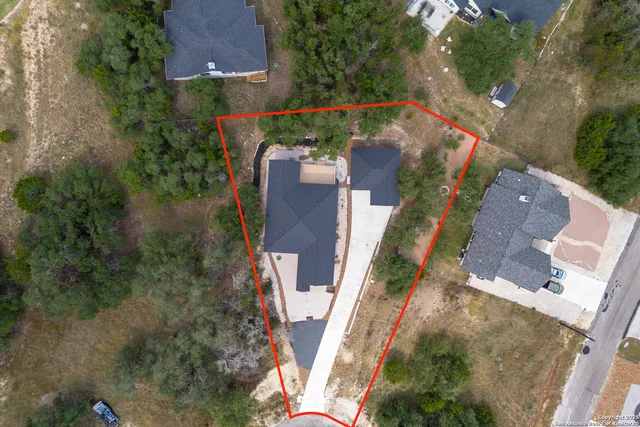 an aerial view of a house with a yard