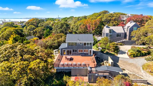 an aerial view of a house with a swimming pool outdoor seating and yard