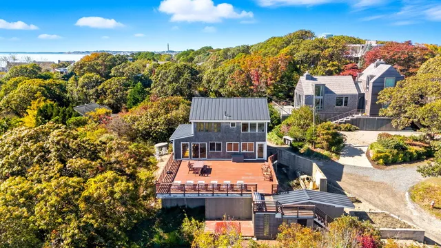 an aerial view of a house with a swimming pool outdoor seating and yard