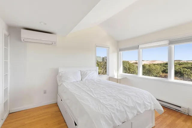a large white bed in a white room