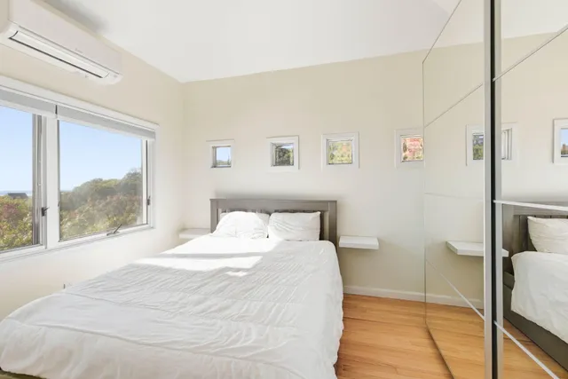 a view of a hallway with workspace and flat screen tv