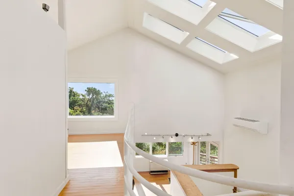a bedroom with a bed and a window with outer view