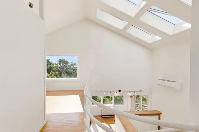 a bedroom with a bed and a window with outer view