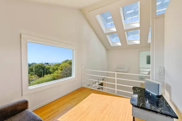 a view of bedroom with wooden floor and windows
