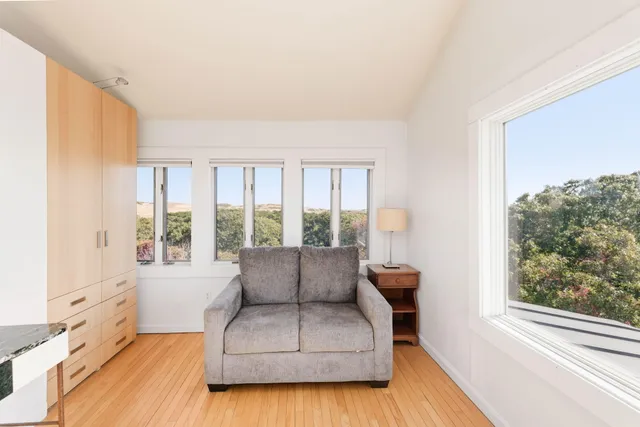 a view of a living room with furniture and a kitchen view