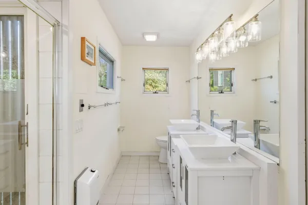 a bathroom with a glass shower door