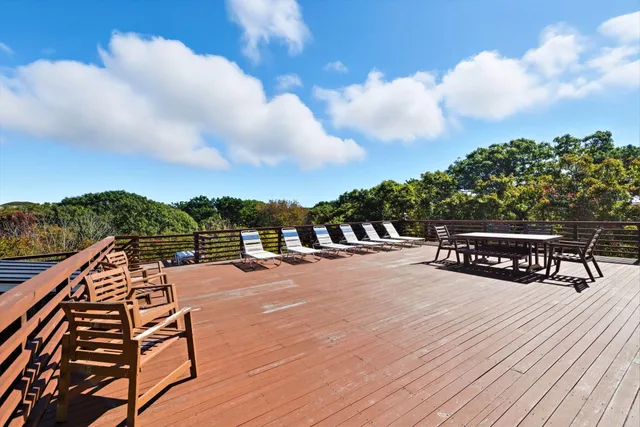 a view of balcony with wooden floor and fence