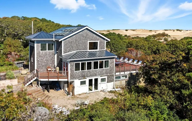 an aerial view of a house with a yard