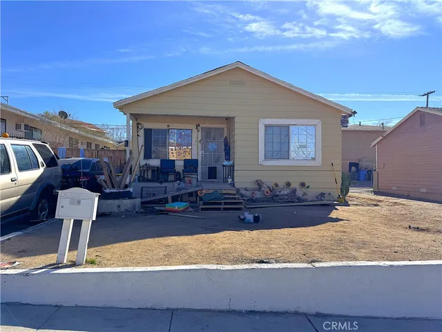 a front view of house with yard outdoor seating and barbeque oven