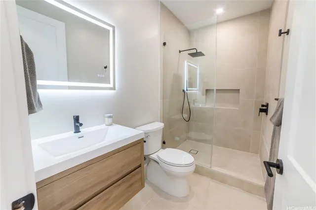 a bathroom with a sink a toilet and shower