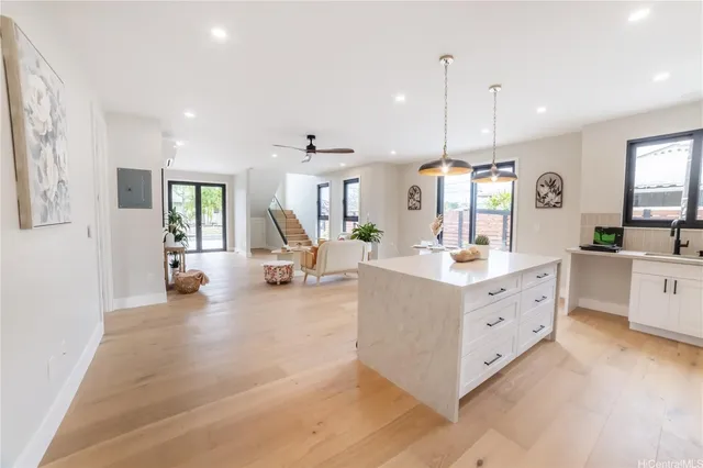 a large white kitchen with cabinets