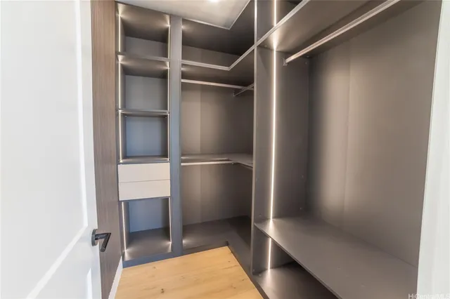 a view of walk in closet with empty racks