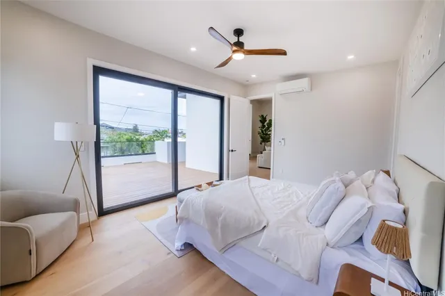 a bed room with a bed and a large window