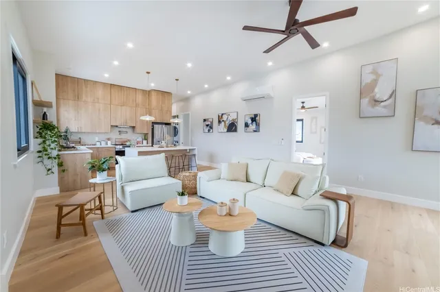 a living room with furniture and a wooden floor