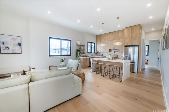 a living room with kitchen island furniture and a wooden floor