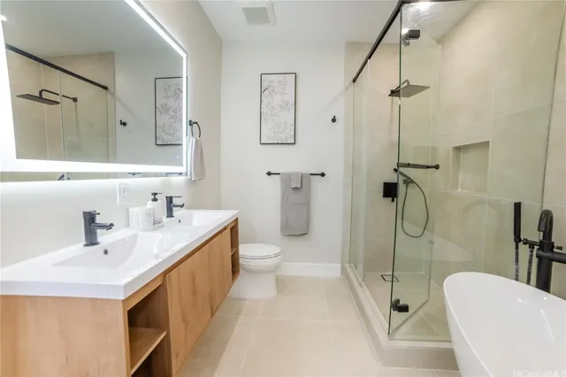 a bathroom with a double vanity sink toilet and shower