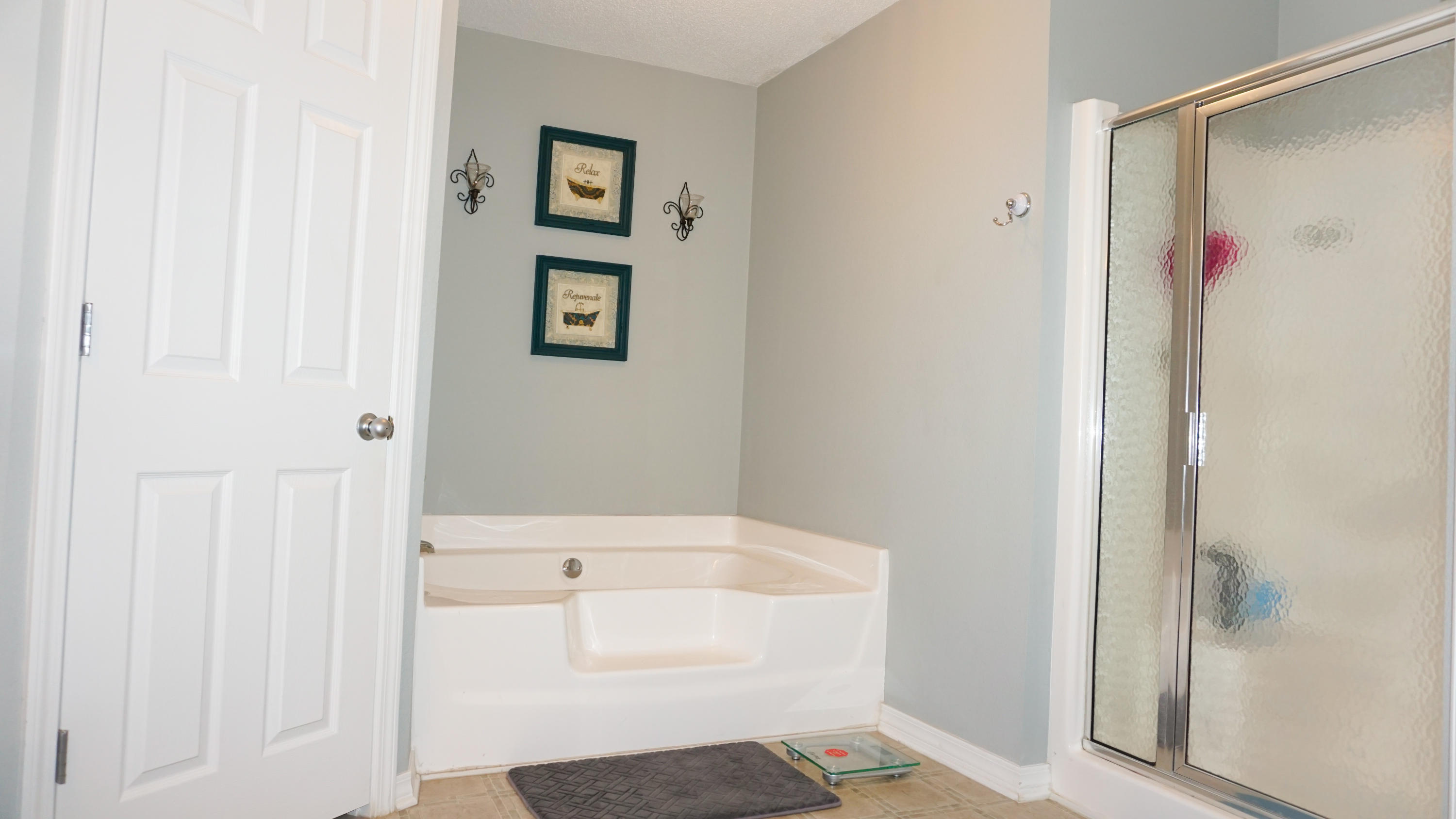 2126 Hagood Loop Crestview, FL 32536 - Photo 11 of 18 a bathroom with a bathtub and a shower