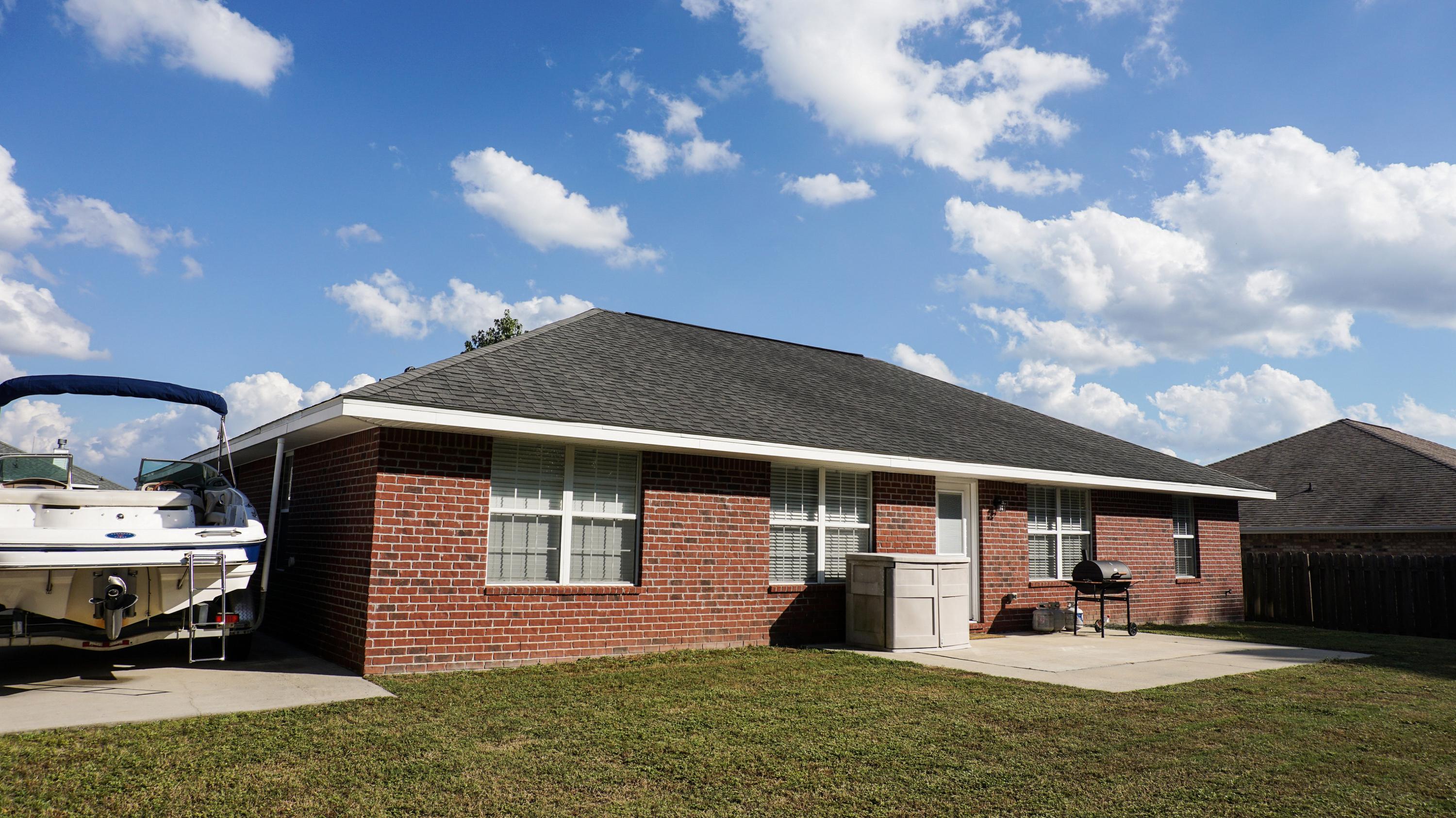 2126 Hagood Loop Crestview, FL 32536 - Photo 16 of 18 a front view of a house with garden